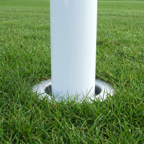 White aluminium rugby post upright dropped into a ground socket set level with the turf