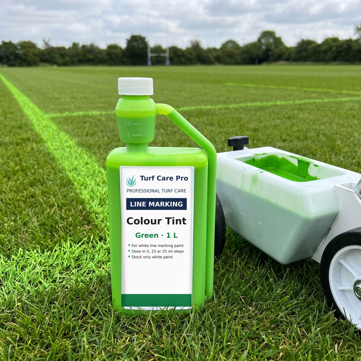 Green colour tint for white line marking paint, 1L bottle beside green pitch lines