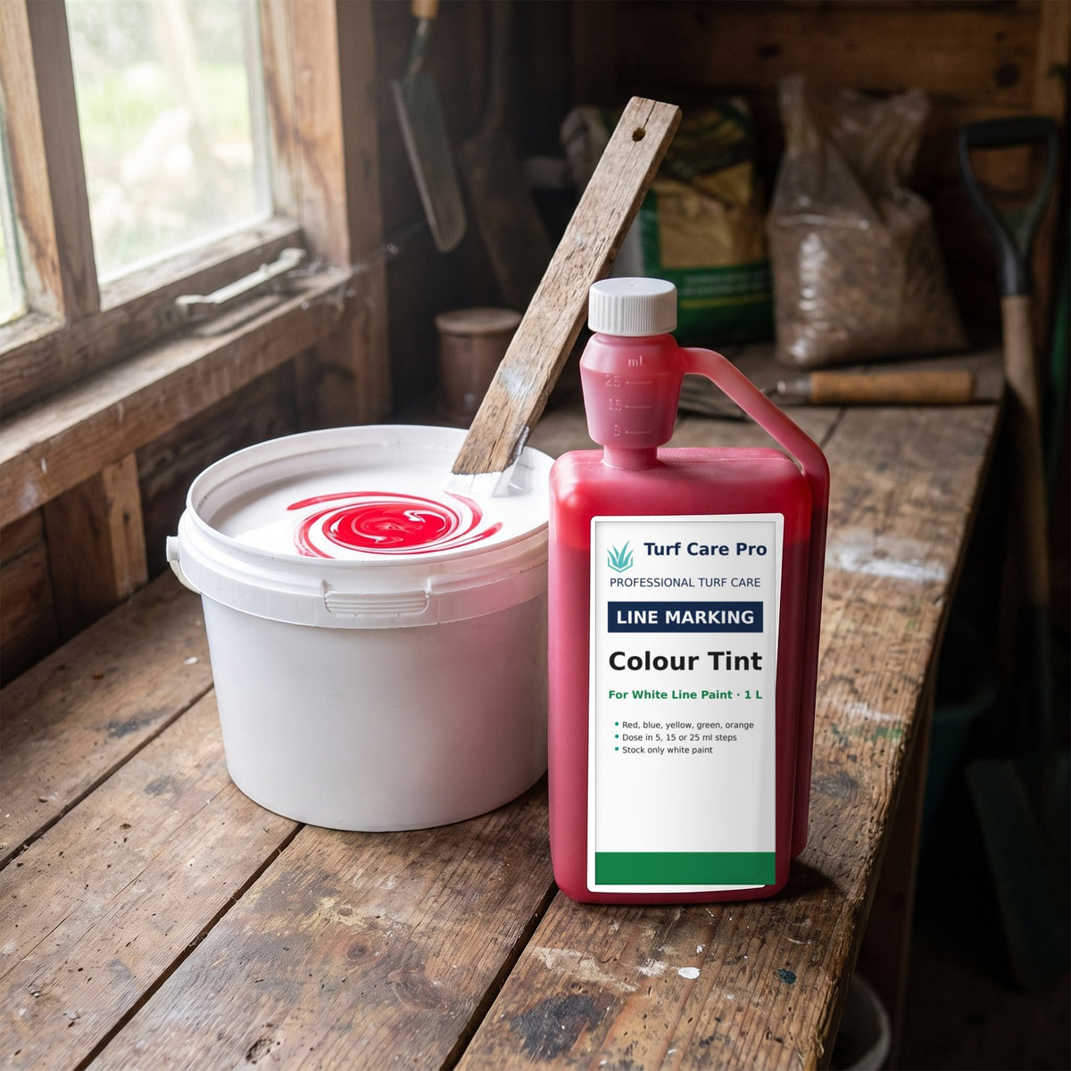 Colour tint being stirred into a bucket of white line marking paint in a groundsman's shed