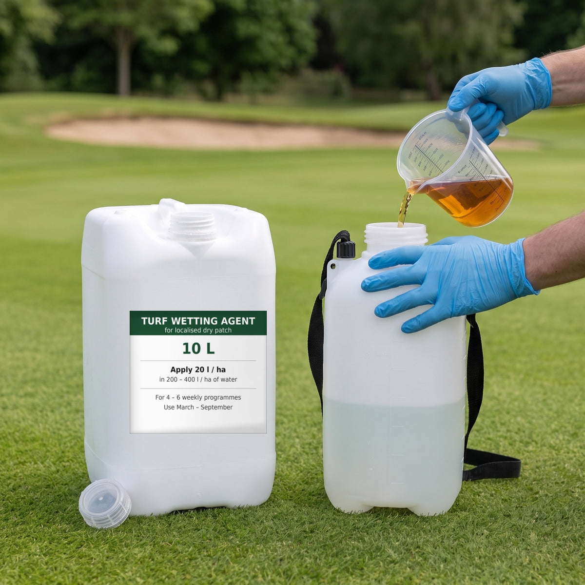 Measured liquid turf wetting agent being added to a knapsack sprayer tank of water beside a golf green