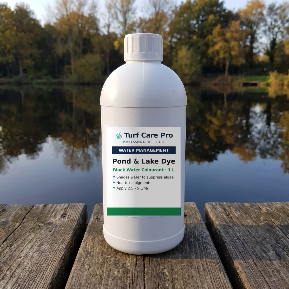 1L black pond and lake dye on a jetty beside a fishing lake with a dark reflective surface