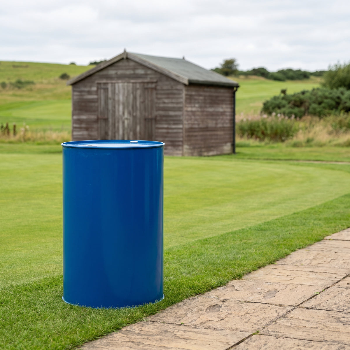 Turf wetting agent 200L drum beside a golf fairway